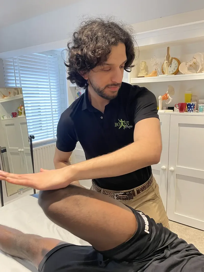 BOOST PHYSIO physiotherapist Aaran mobilising a patient's knee