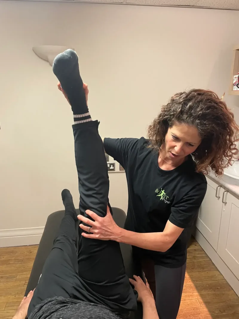 BOOST PHYSIO physiotherapist Katy stretching a patient's leg