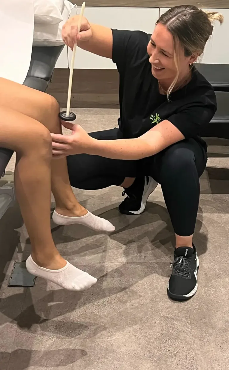 Catriona Benson testing a patient's reflexes