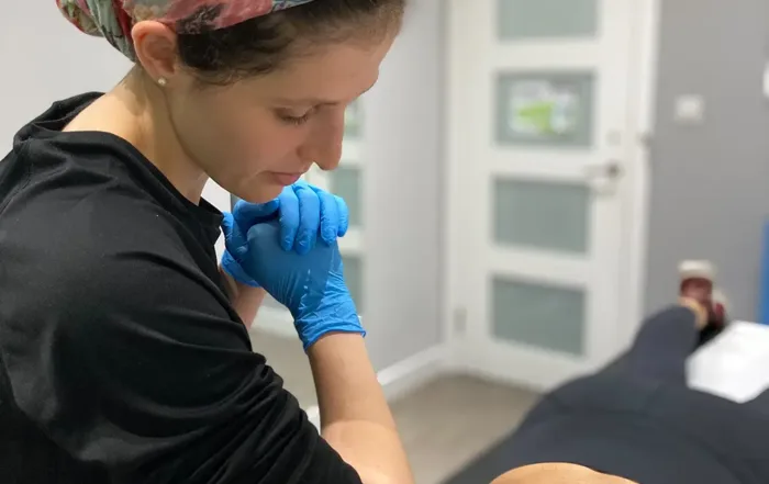 Micki Hammond Physiotherapist In Hendon Treating a patient