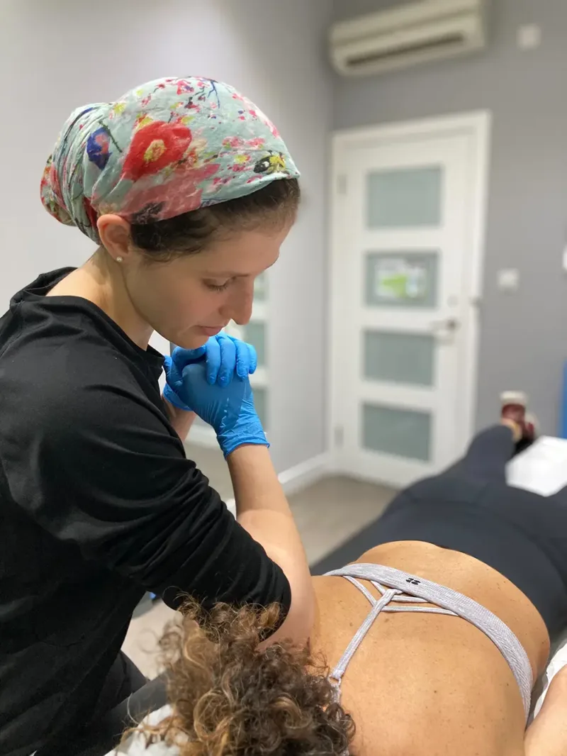 BOOST PHYSIO physiotherapist Micki giving soft tissue treatment to ease low back muscle spasm