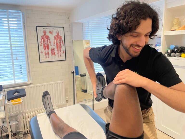 Aaran assessing a patient's knee at our Hendon clinic