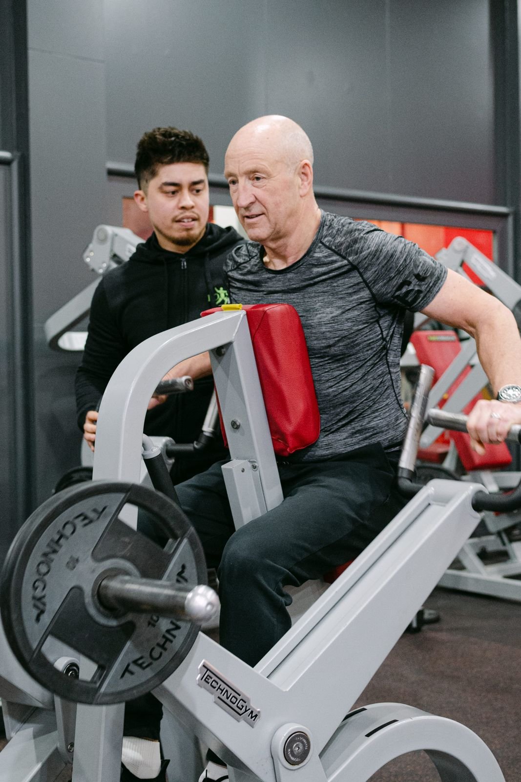 BOOST PHYSIO physiotherapist guiding an older patient through gym-based strength training