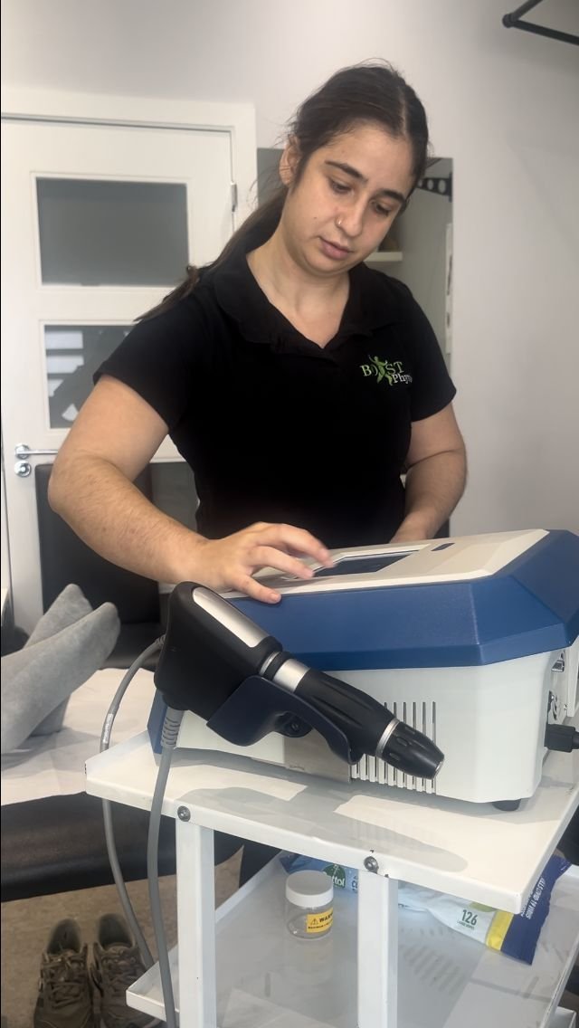 BOOST PHYSIO physiotherapist preparing a shockwave therapy machine