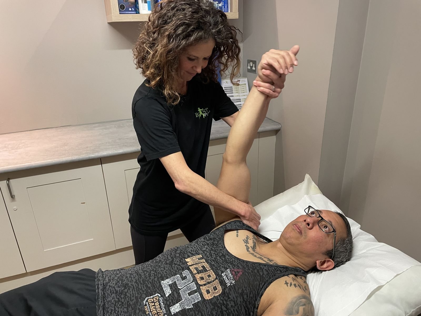 BOOST PHYSIO physiotherapist mobilising a stiff shoulder in clinic